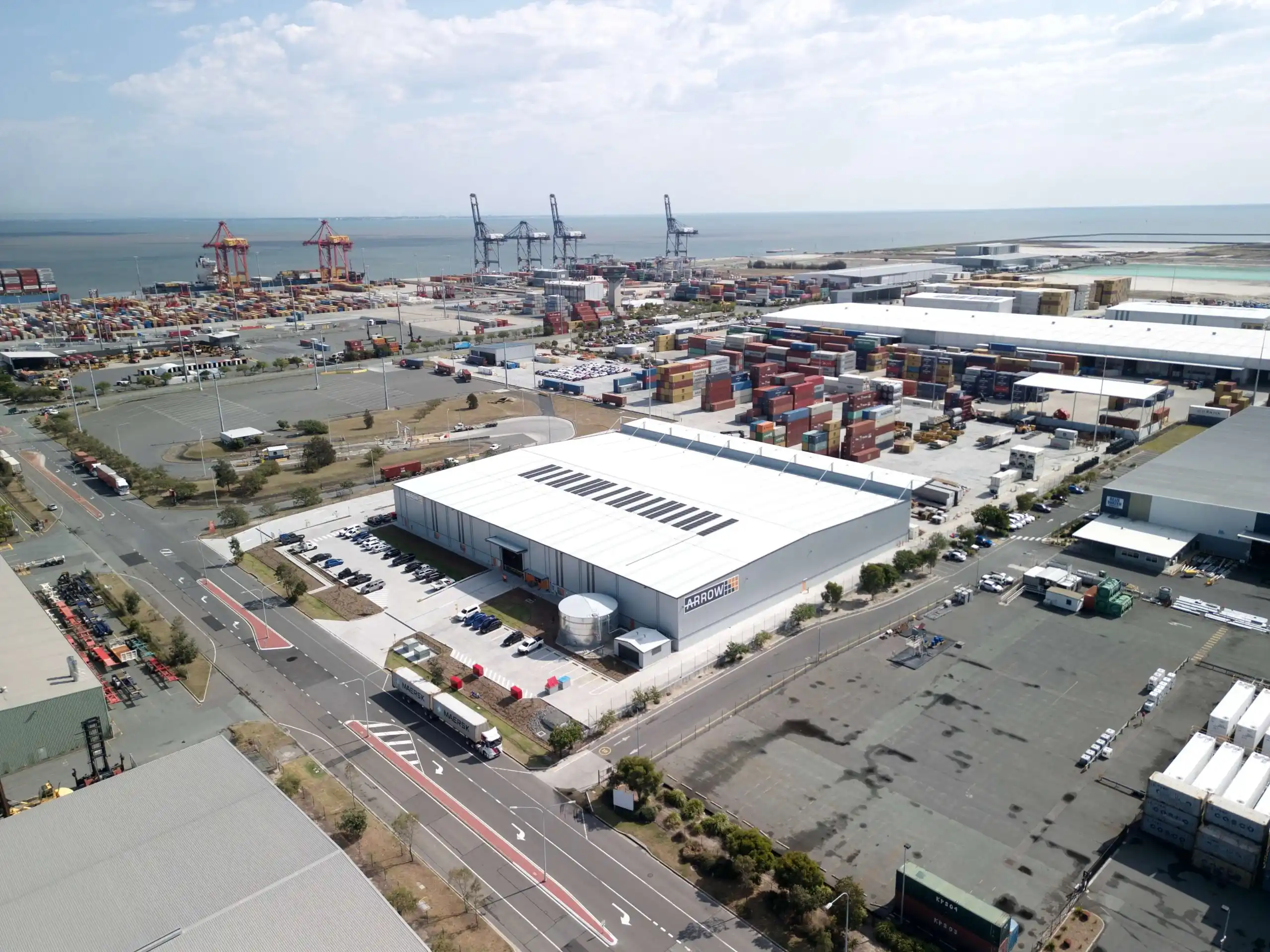 Aerial view of a logistics depot beside a container port