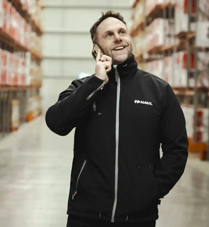 Pete Lynagh on the phone in a warehouse aisle